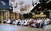 Велика зала з учасниками заходу, сидячими у круговій розстановці.