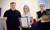 Дві жінки та чоловік фотографуються у приміщенні.