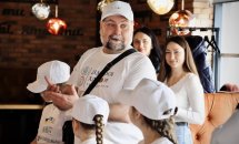 Чоловік у білій футболці розповідає щось дітям.