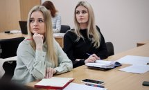 Дві жінки з світлим волоссям сидять за столом.