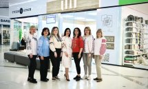Група жінок  вишиванках позують у торговому центрі.