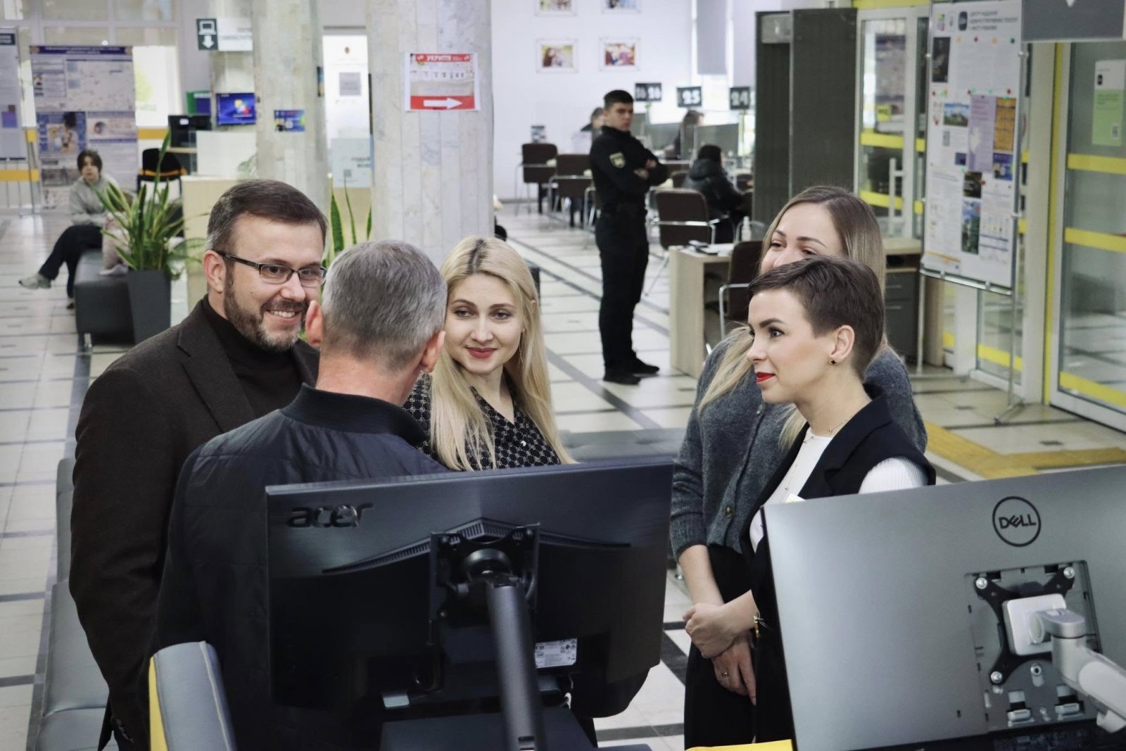 У приміщенні ЦНАПу чоловік та двоє жінок, обговорюють питання з працівницею.