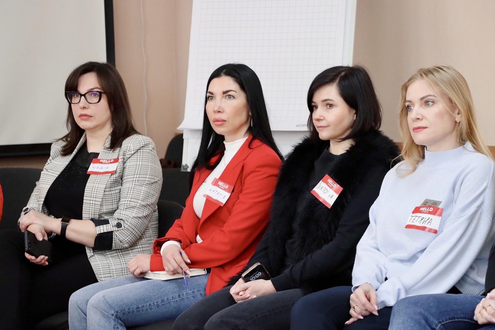 Чотири жінки сидять у приміщенні.