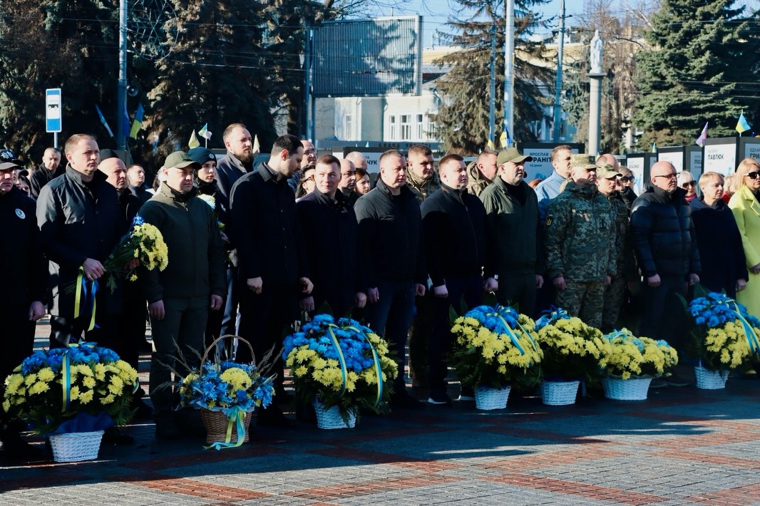 Багато людей перебувають на вулиці, перед ними стоять корзини з квітами.